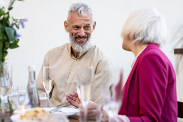 Family and friends celebrating at dinner on a rooftop terrace