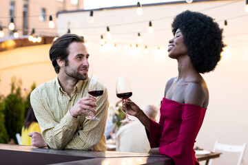 Family and friends celebrating at dinner on a rooftop terrace