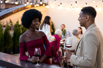 Family and friends celebrating at dinner on a rooftop terrace
