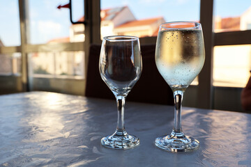 Full and empty glass stand on the table