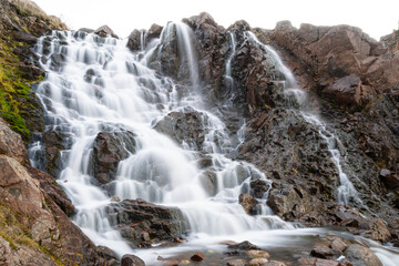 Beautiful waterfall on long exposure in Teriberka, shore of arctic ocean, travelling to north of Russia