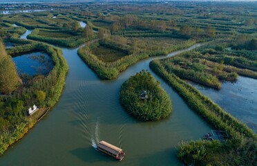 Fototapeta na wymiar Tourists visit the Hongze Lake Wetland Reed Maze scenic area in Suqian city, East China's Jiangsu Province on Oct. 6, 2021, the sixth day of the National Day holiday.
