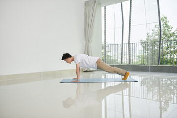 man doing plank exercise at home