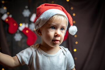 Cute baby boy surrounded with Christmas decorations