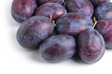 Obraz premium Plums, a lot of very beautiful blue plums, between plums some leaves, background.
