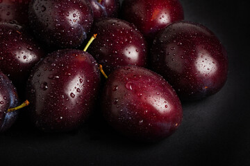 Fresh plums with drops close up. Plums background