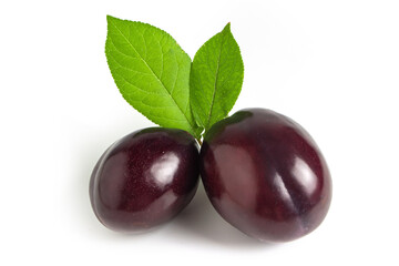 Plums with plum leaves on a white background.