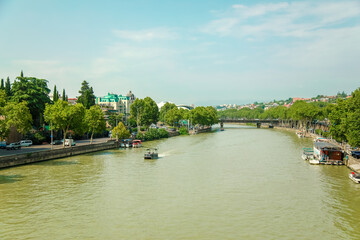 Obraz premium canal, green wide river in the city