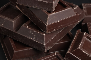 Broken pieces of dark chocolate close up
