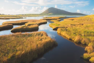  Beautiful golden light on the salt marsh mountain landscape at Northton on the Isle of Lewis and Harris on the Outer Hebrides, Scotland, UK. © Stephen