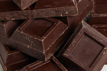 Broken pieces of dark chocolate close up