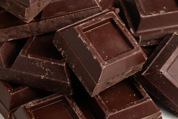 Broken pieces of dark chocolate close up