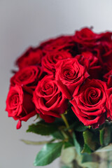 Close up bouquet of fresh dark red roses on neutral background