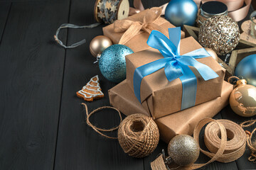 Festive background with gift boxes and decorations on a dark background.