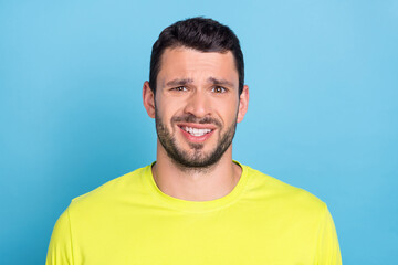 Photo of unhappy upset young man dislike face dilemma bad mood guy isolated on blue color background