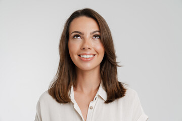 Young european woman in shirt smiling and looking upward