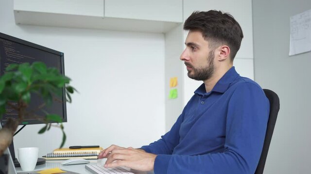 Software developer writing code working from home office