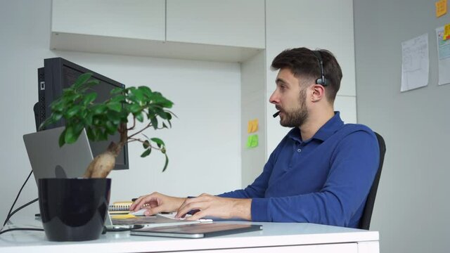 Young software develeoper having call writing computer code