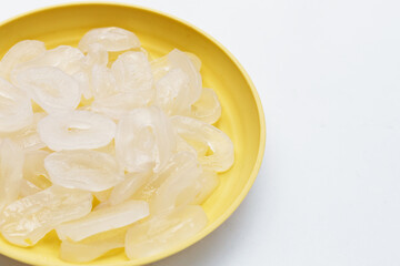 Toddy palm slices in yellow plate on white background.