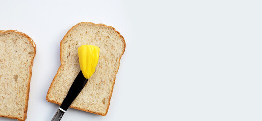 Bread slices with butter on white background.