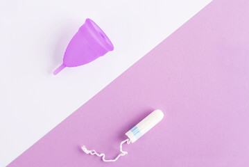 Silicone menstrual cup and tampon. Women's health and alternative hygiene, zero waste alternatives, female intimate hygiene period products, critical days. Top view, White and violet