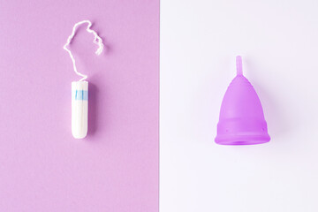 Silicone menstrual cup and tampon. Women's health and alternative hygiene, zero waste alternatives, female intimate hygiene period products, critical days. Top view, White and violet