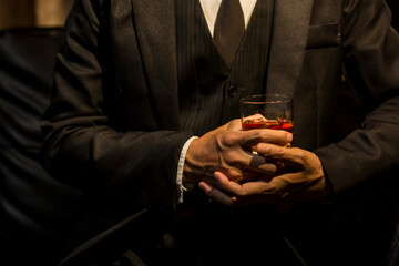 Obraz na płótnie Canvas Closeup businessmen holding a glass of whiskey