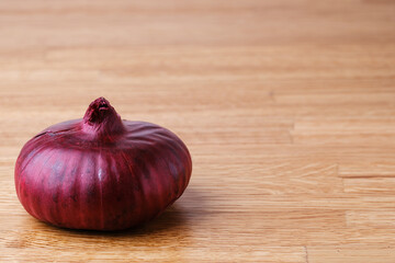 A large head of a red Yalta variety onion. Close-up. Selective focus. Copyspace