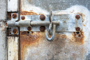 An old rusty metal bar without lock at an harbour