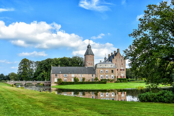 Fototapeta na wymiar Castle in Vilsteren is situated on an island in a dead river arm of the Overijsselse Vecht. A stone arch bridge gives access to the castle. Netherlands, Holland, Europe