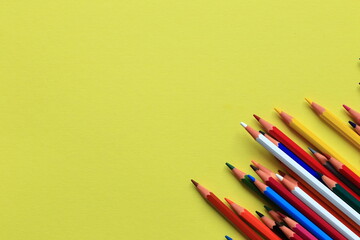 Colored pencils on a colored background. A set of pencils for drawing. Background from pencils.