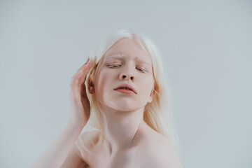 Beauty image of an albino girl posing in studio wearing lingerie. Concept about body positivity,...