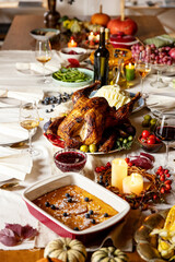 Close-up festive decorated table with roasted turkey and holiday traditional food, dishes. Happy Thanksgiving day