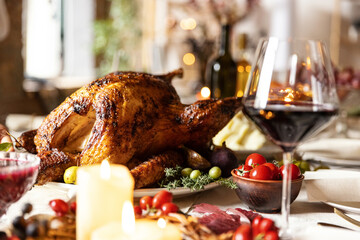 Close-up festive decorated table with roasted turkey and holiday traditional food, dishes. Happy Thanksgiving day