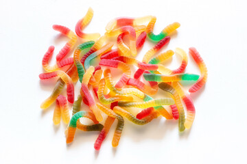 jelly gummy worms scattering candy sweets close-up on a white background