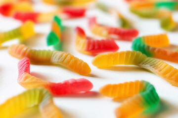 gummy jelly worms multicolored close-up selective focus on white background