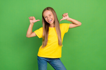 Portrait of attractive cheerful girl demonstrating herself winking isolated over bright green color...