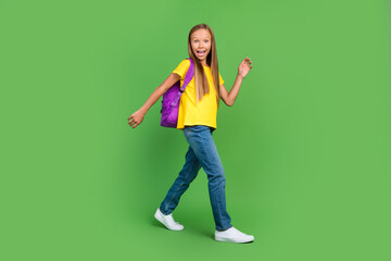Fototapeta na wymiar Full length body size view of attractive cheerful amazed girl going visit secondary school isolated over vivid green color background