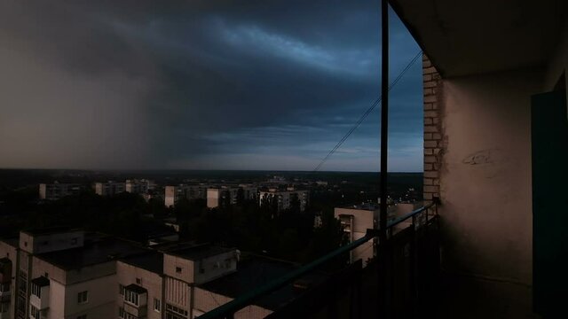 Time lapse of clouds through view of derelict building window at balcony