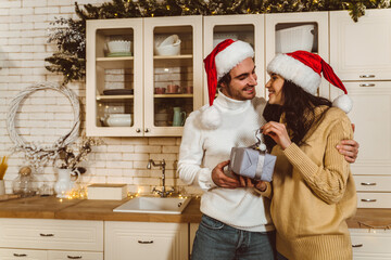 Cinematic image of a couple celebrating christmas at home.