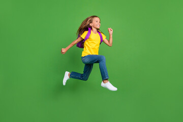 Fototapeta na wymiar Full length body size view of pretty motivated cheerful girl learner jumping running isolated over bright green color background