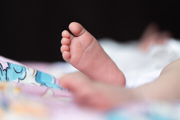 Naklejka premium Baby's foot on a diaper with a picture