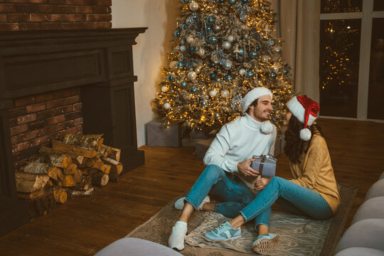 Cinematic image of a couple celebrating christmas at home.