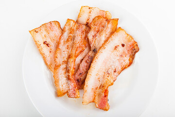 fried bacon to add to pizza on a white plate