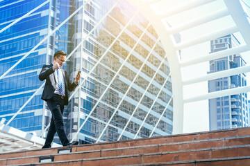 Young businessman in feeling happy because receive replies mail from business partners who agree to do business.