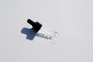 Open cap with dropper pipette with serum. Light background with daylight and the appearance of the...