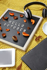 Hello October written on the letter board with multimedia accessories flat lay concept