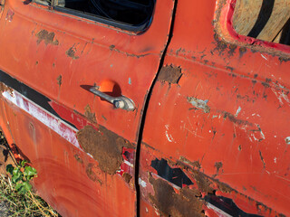 Old abandoned car. Detail of old rusty car part.