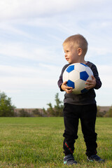 Young boy with ball soccer player smiling