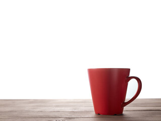 Red cup on wooden table with isolated background